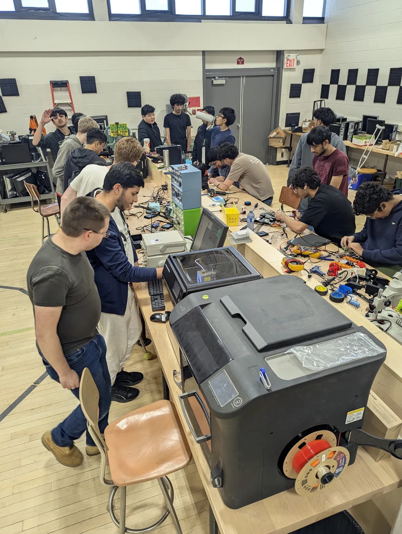 Cameron Robotics students working with tools and electronics in the school workshop